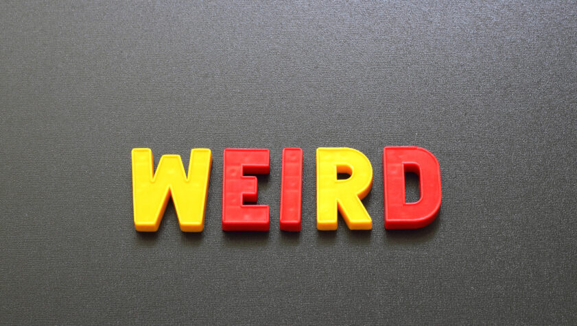 Letter magnets spelling out "weird."